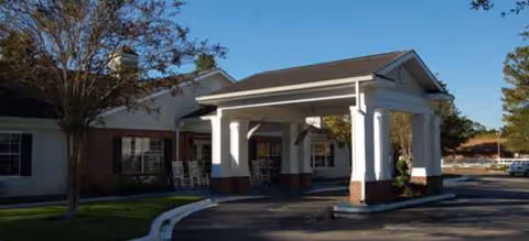 Exterior view of Brookdale Orange Park entrance with a covered drop off and columns.