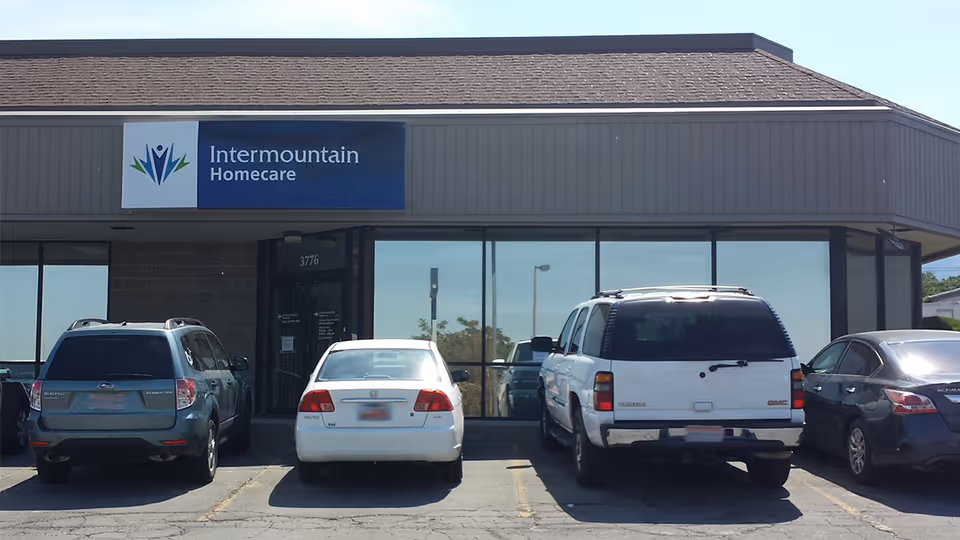 Exterior view of Intermountain Homecare storefront with parked cars in front.