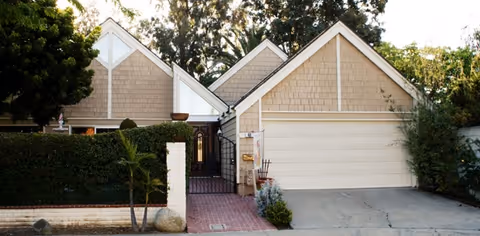 Exterior view of The Oaks at Sweeten Creek with a gated entry and driveway