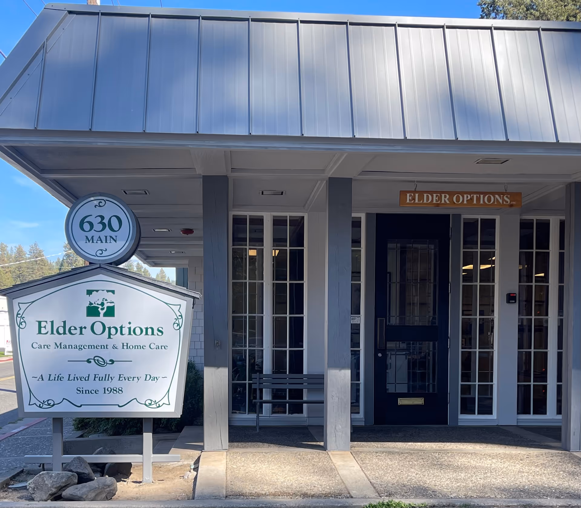 Front exterior of Elder Options facility with 630 Main sign and glass doors.