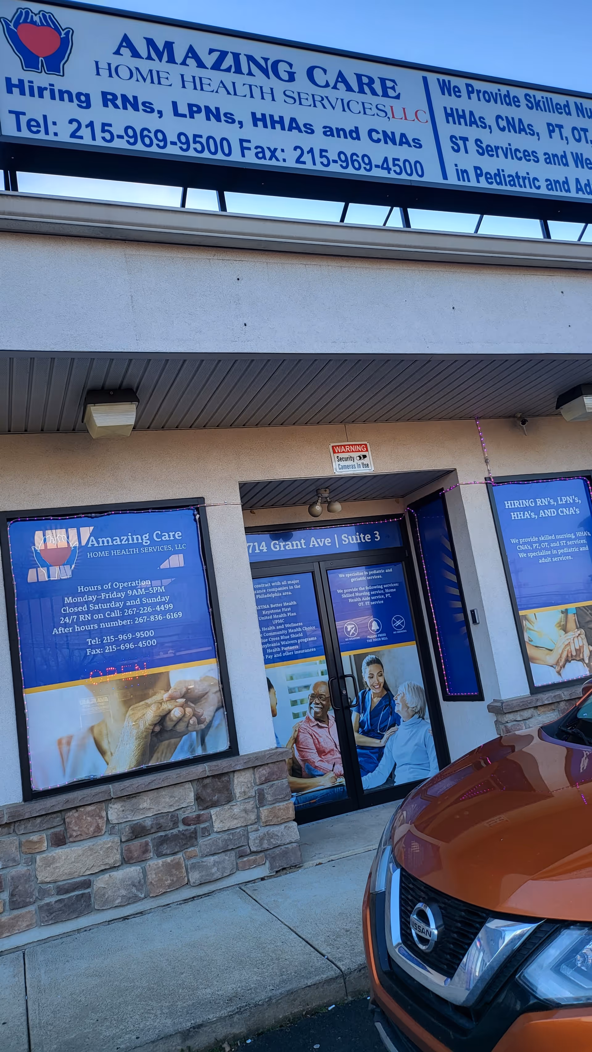 Exterior storefront of Amazing Care Home Health Services with blue signage and a parked car.