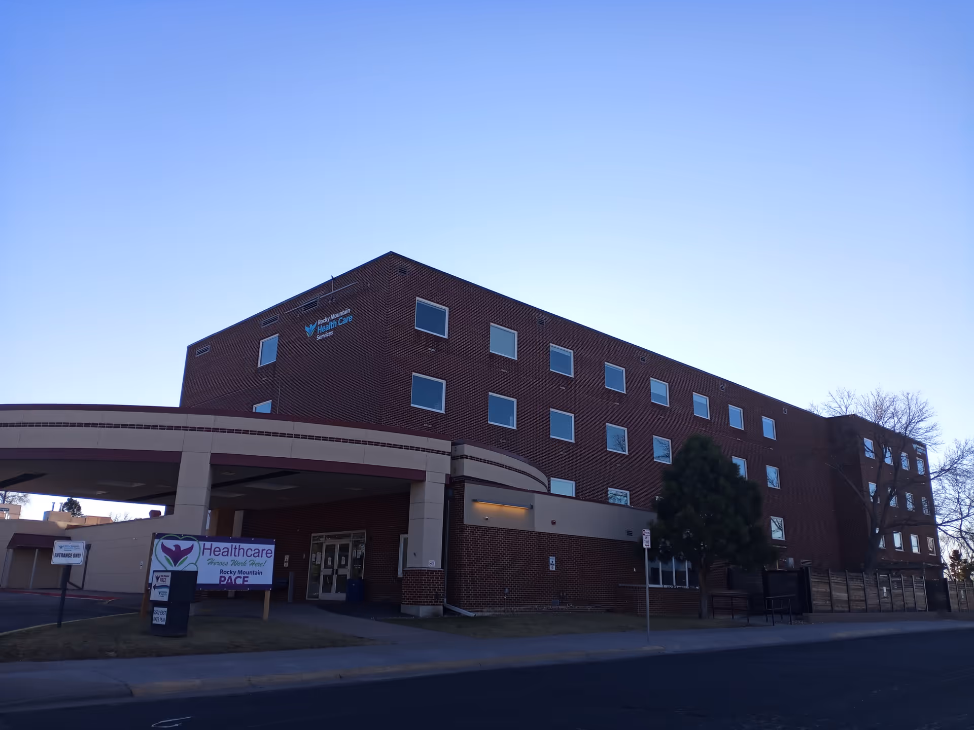 Exterior view of Rocky Mountain Health Care Services, a brick building with a covered entrance.