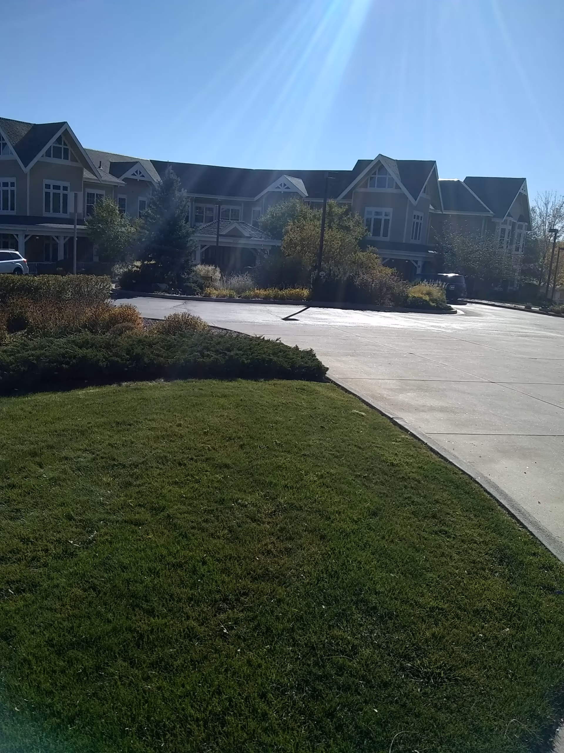 Exterior view of MorningStar at Applewood, a multi-story senior living building with landscaping.