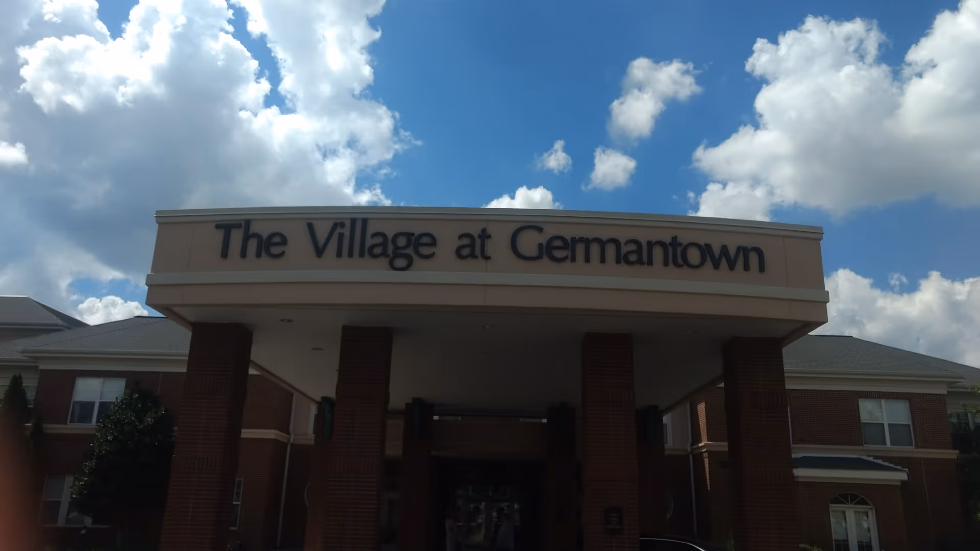 Exterior view of The Village at Germantown entrance with brick columns.