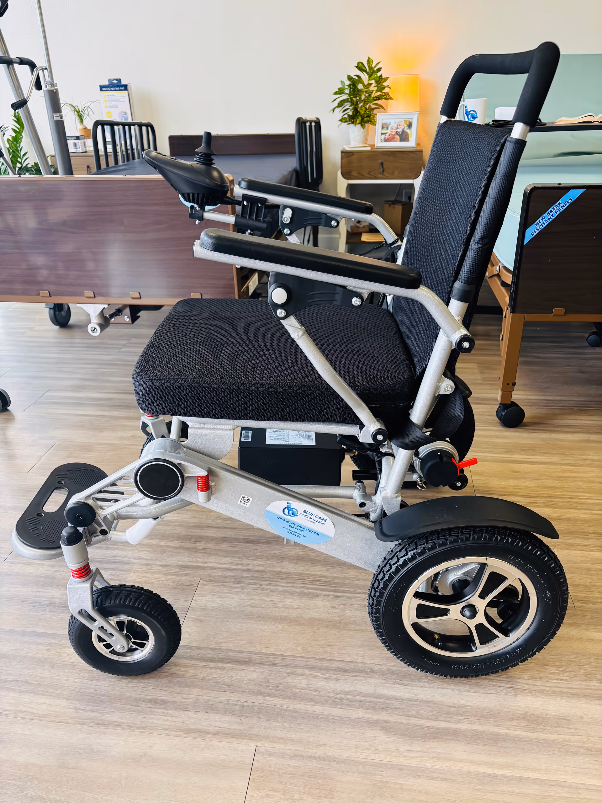 A powered wheelchair is parked inside a senior care facility's reception area.