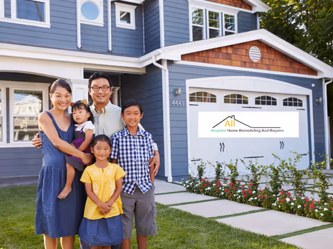 Family of five stands in front of a blue house with remodeling sign.