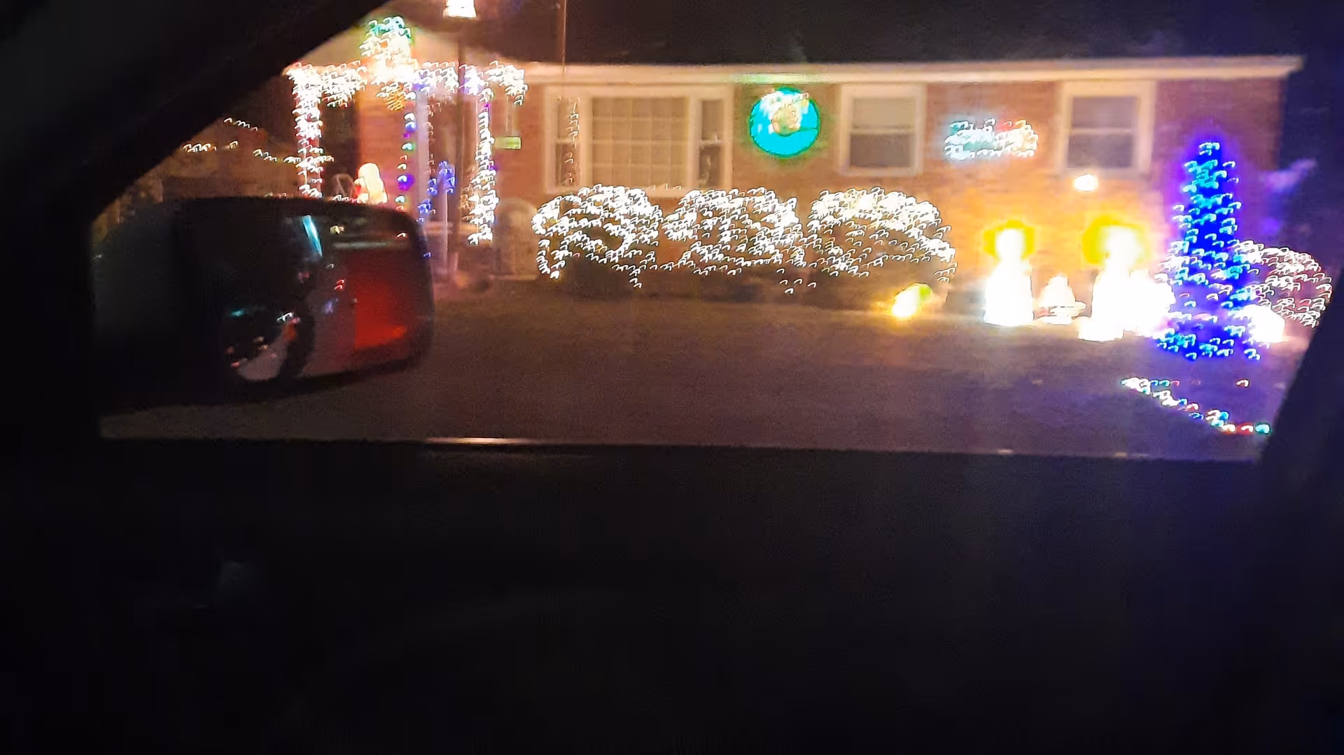 Caring Hearts facility exterior illuminated with festive holiday lights at night.