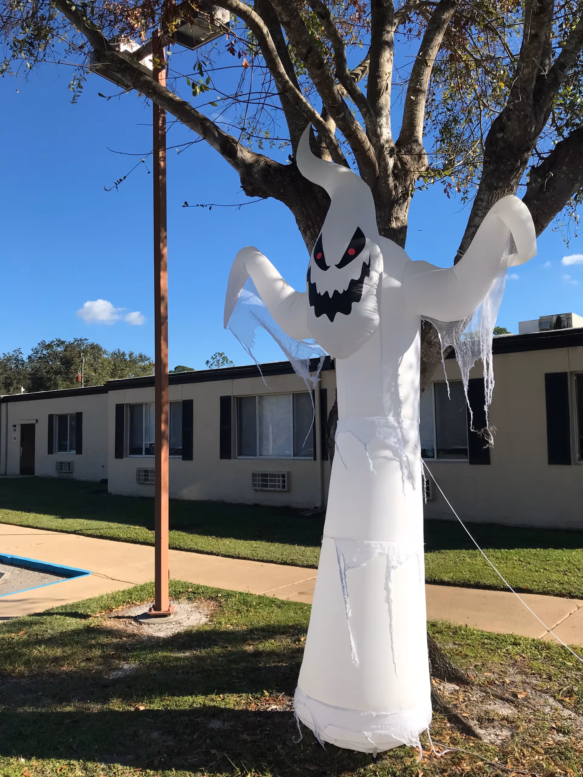 Large inflatable white ghost decoration outside LaBelle Health and Rehabilitation Center.