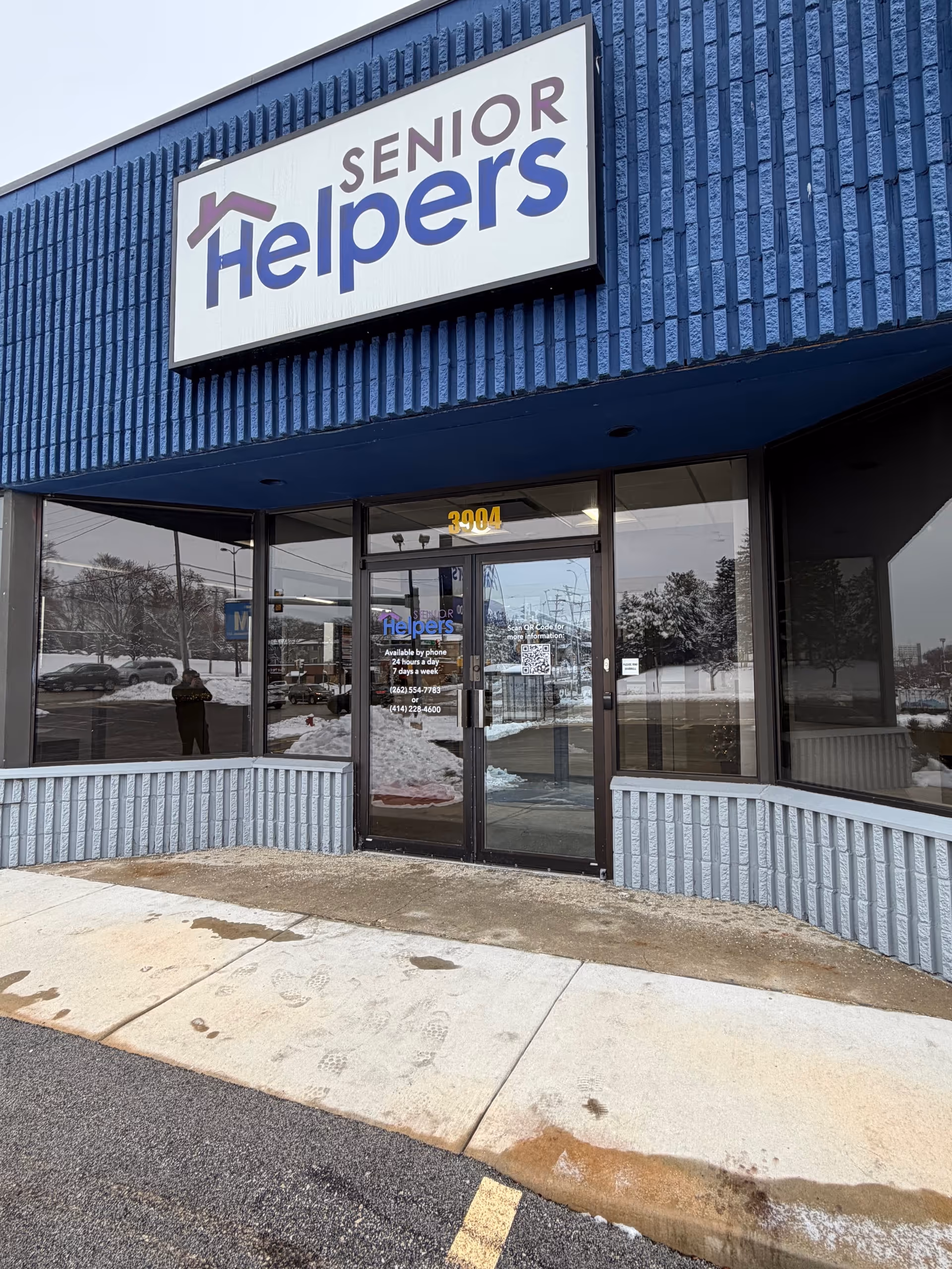 Exterior of a blue building with a Senior Helpers sign above the entrance.