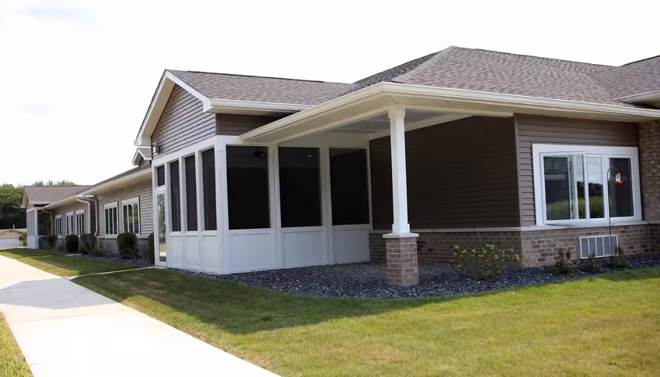 Exterior view of Autumn Trace Plymouth Assisted Living facility with a covered entrance.