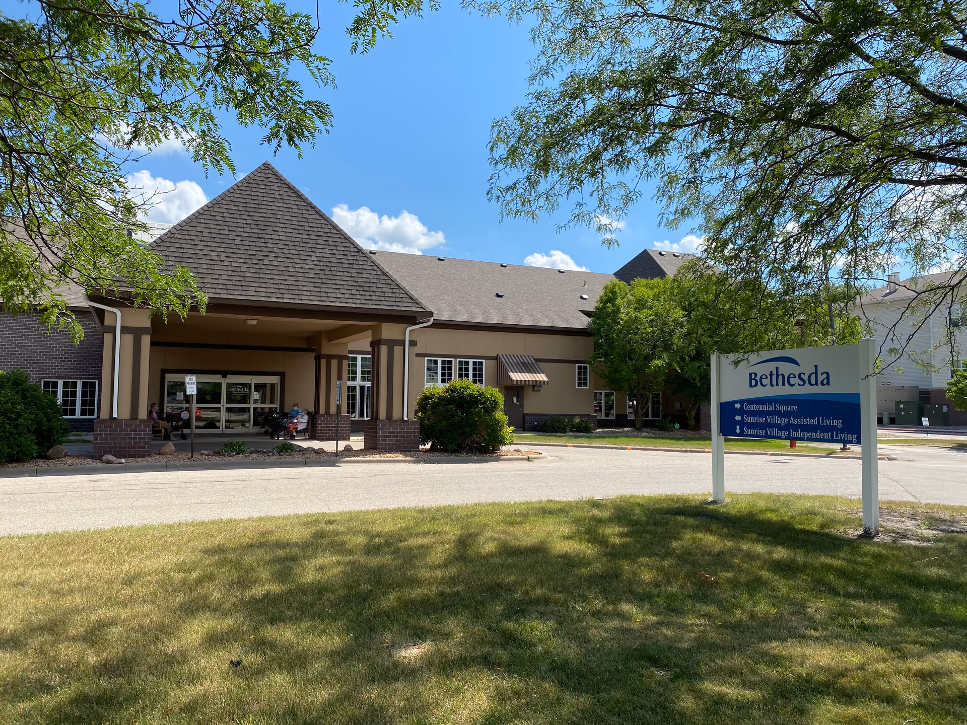 Exterior view of Bethesda Assisted Living facility with entrance and sign.