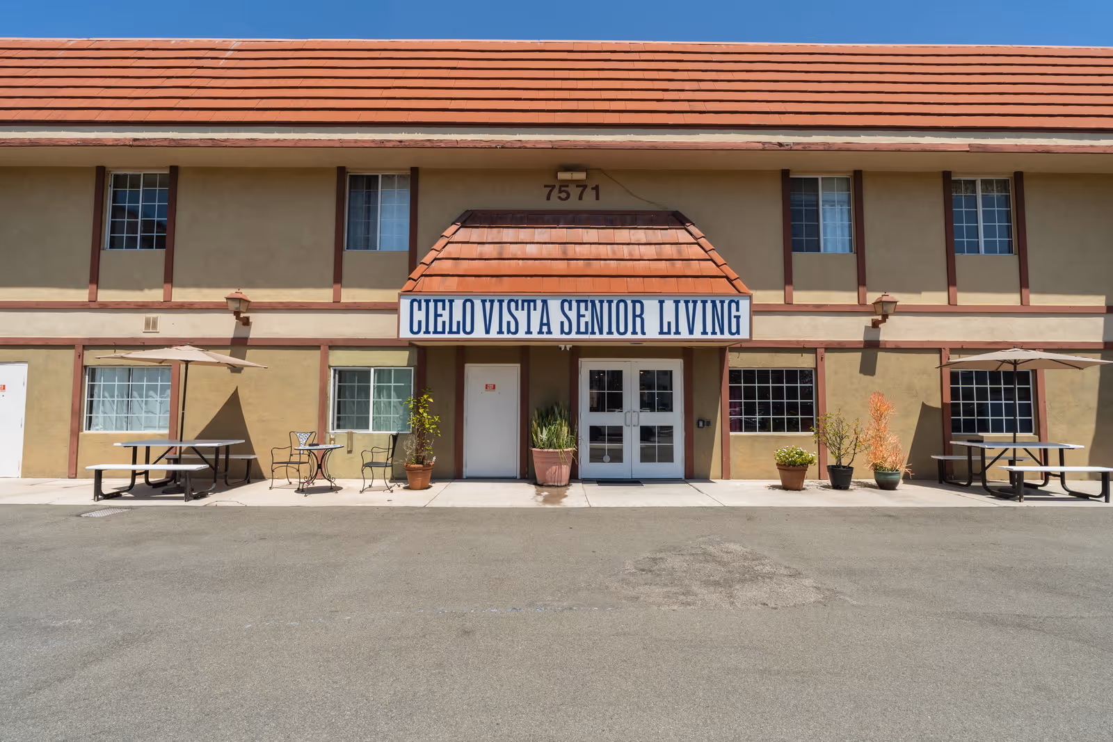 Exterior view of Cielo Vista Senior Living with outdoor seating and entrance.