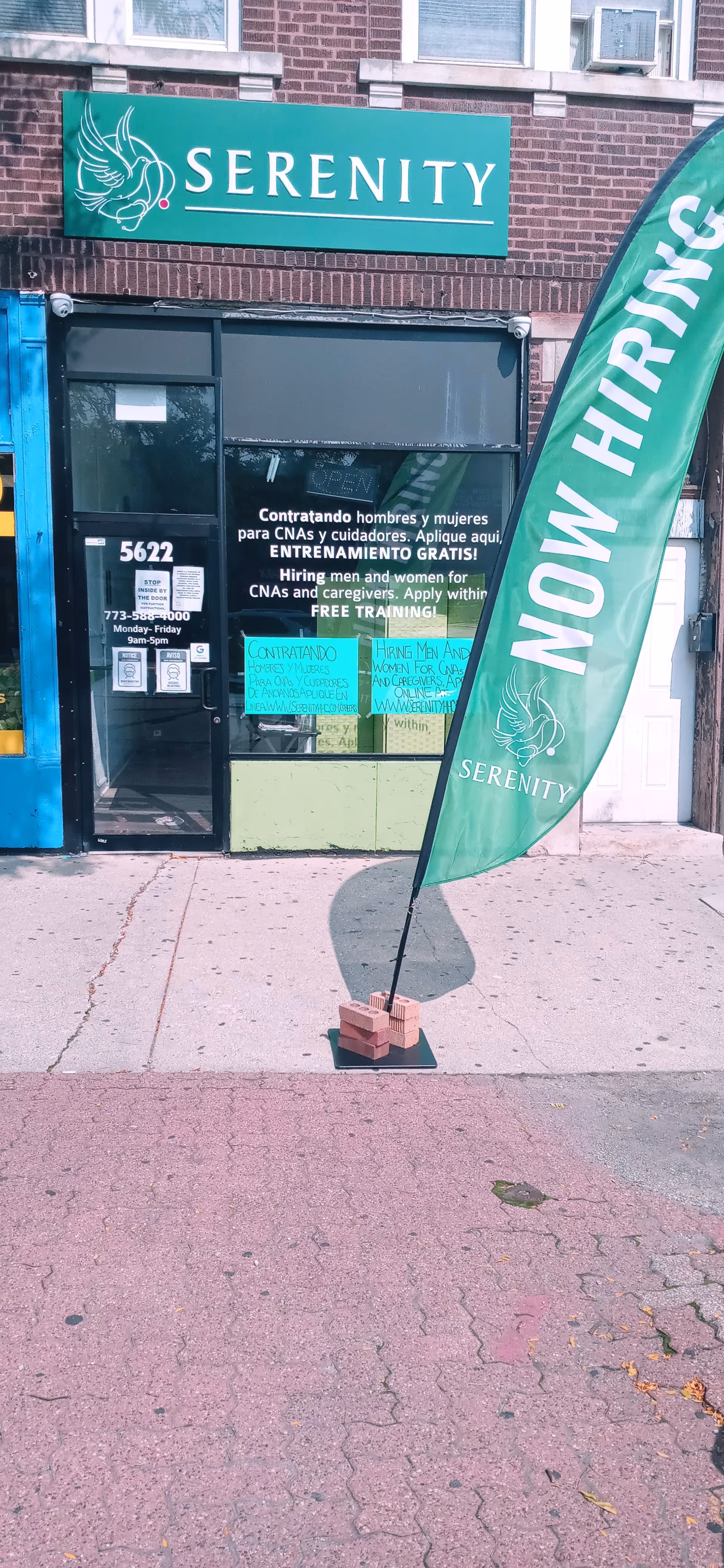 Front storefront of Serenity Home Healthcare, Inc. with now-hiring banner and teal sign.