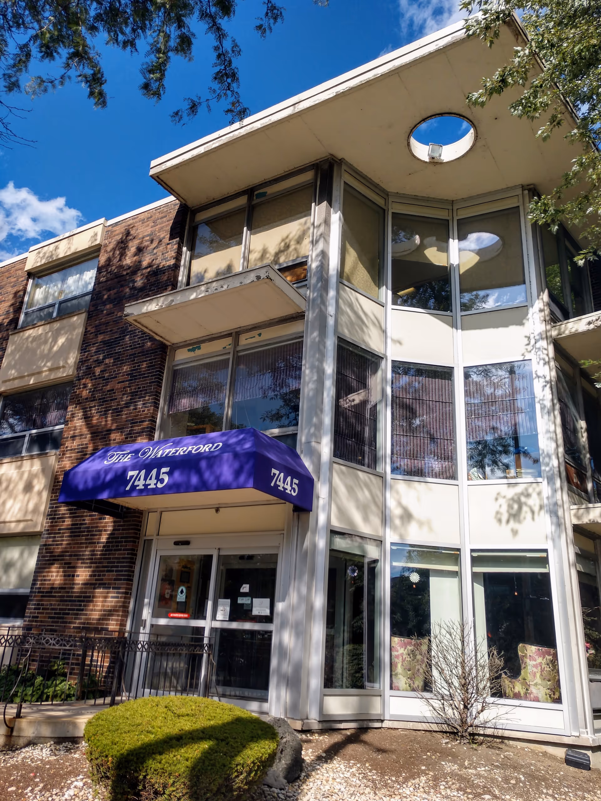 Exterior view of The Waterford Care Center entrance with a purple awning.