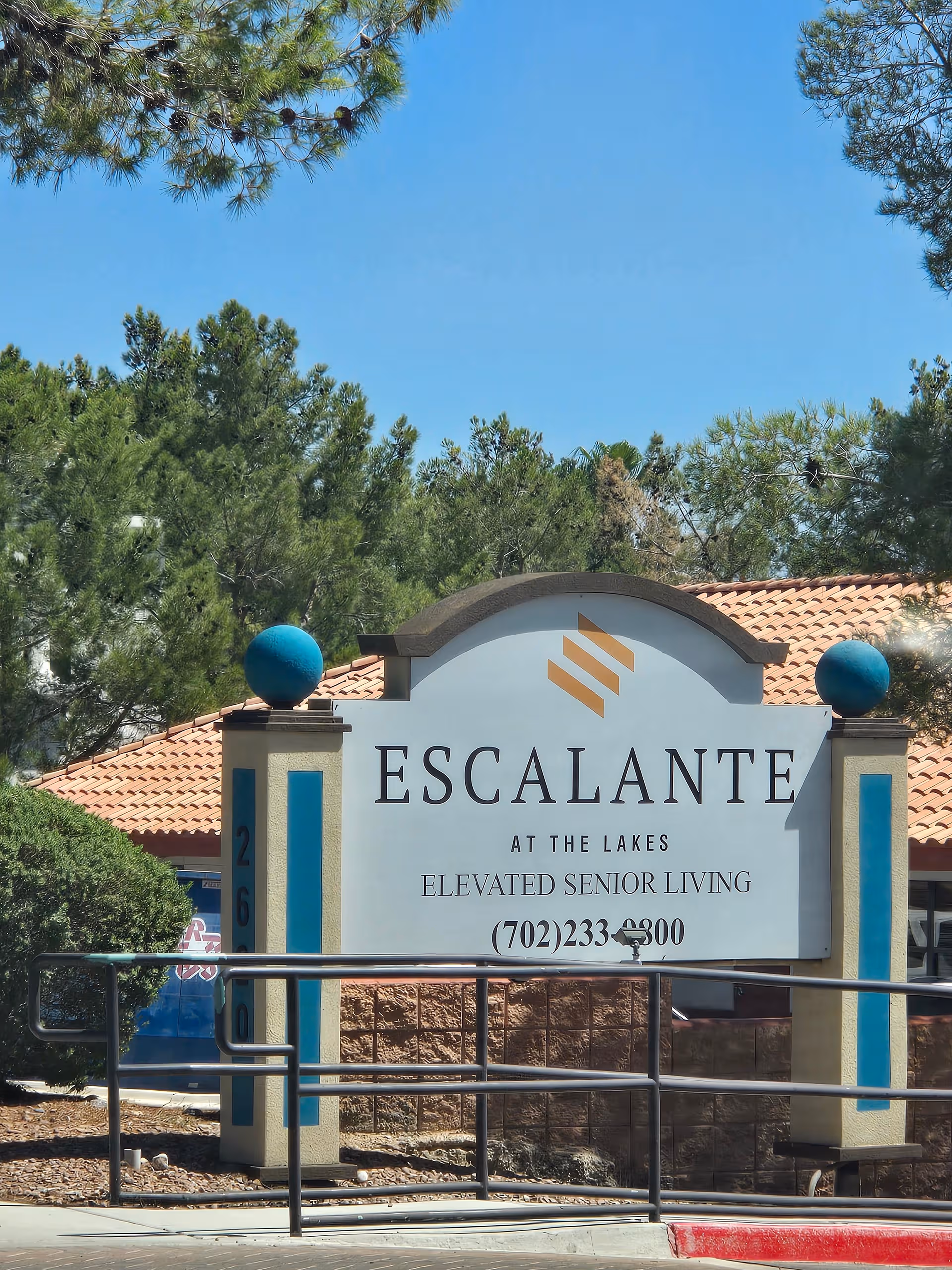 Exterior view of Escalante at the Lakes sign and entrance with landscaping