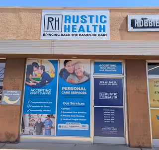 Exterior view of Rustic Health LLC building with signage and promotional posters.