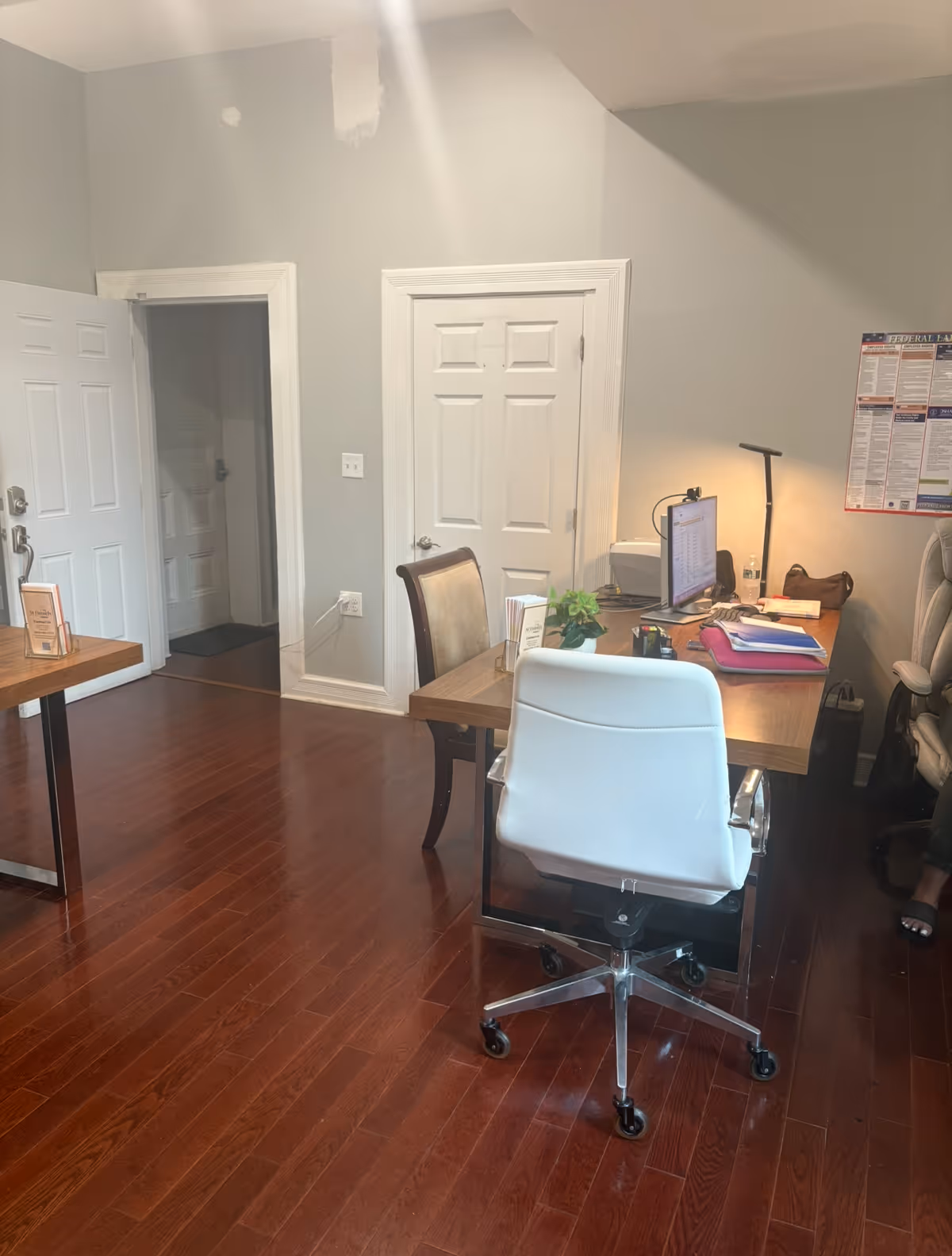 Office workspace in a senior living facility with desk, computer, and chair.