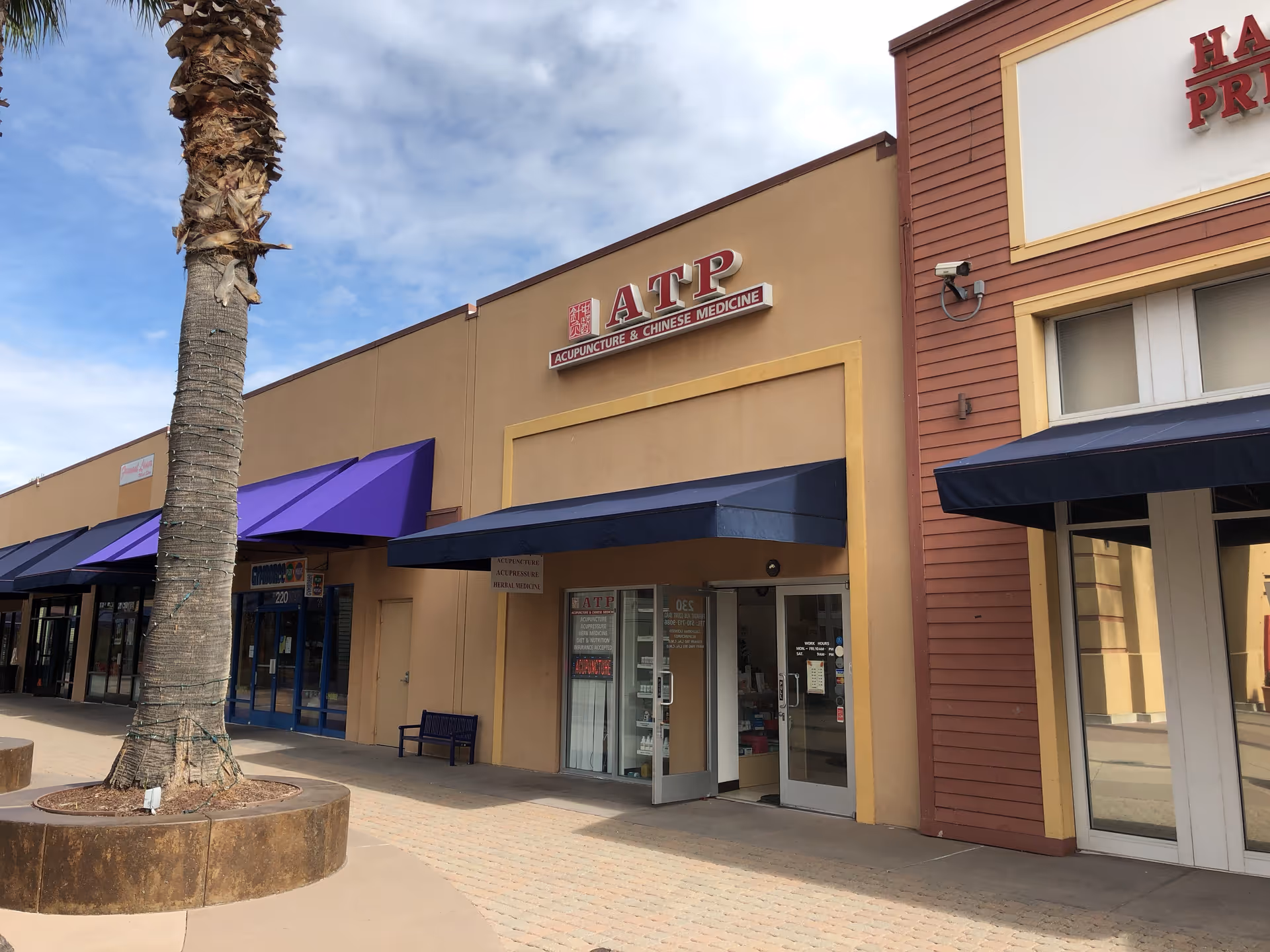 Exterior view of a strip mall storefront for ATP Acupuncture & Chinese Medicine.