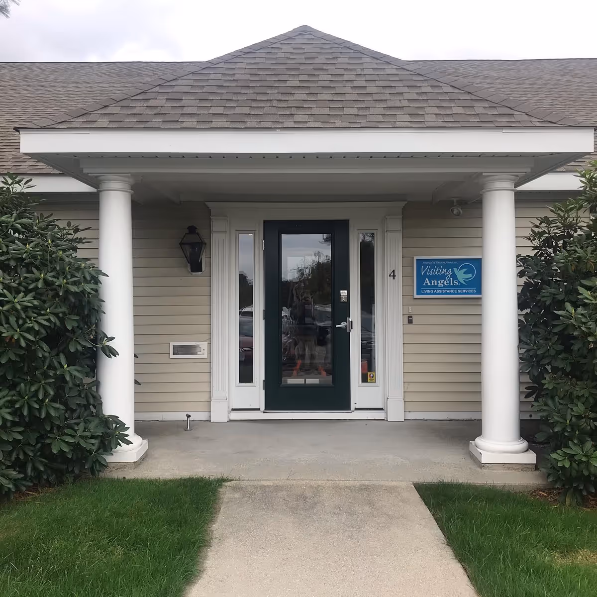 Front entrance of Visiting Angels Senior Home Care with white columns and signage