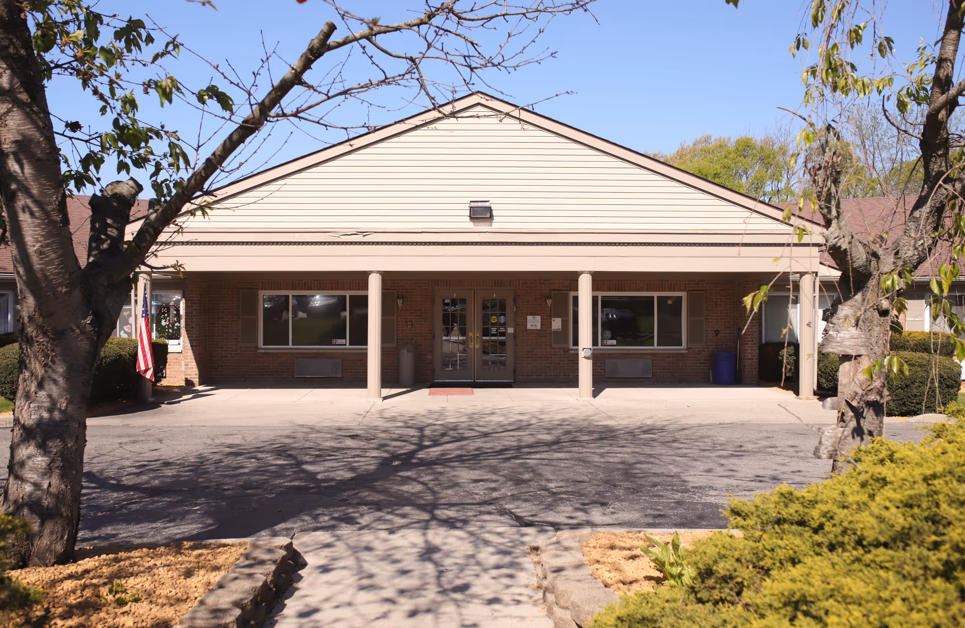 Front view of a ProMedica Kettering senior living building with a covered entrance.