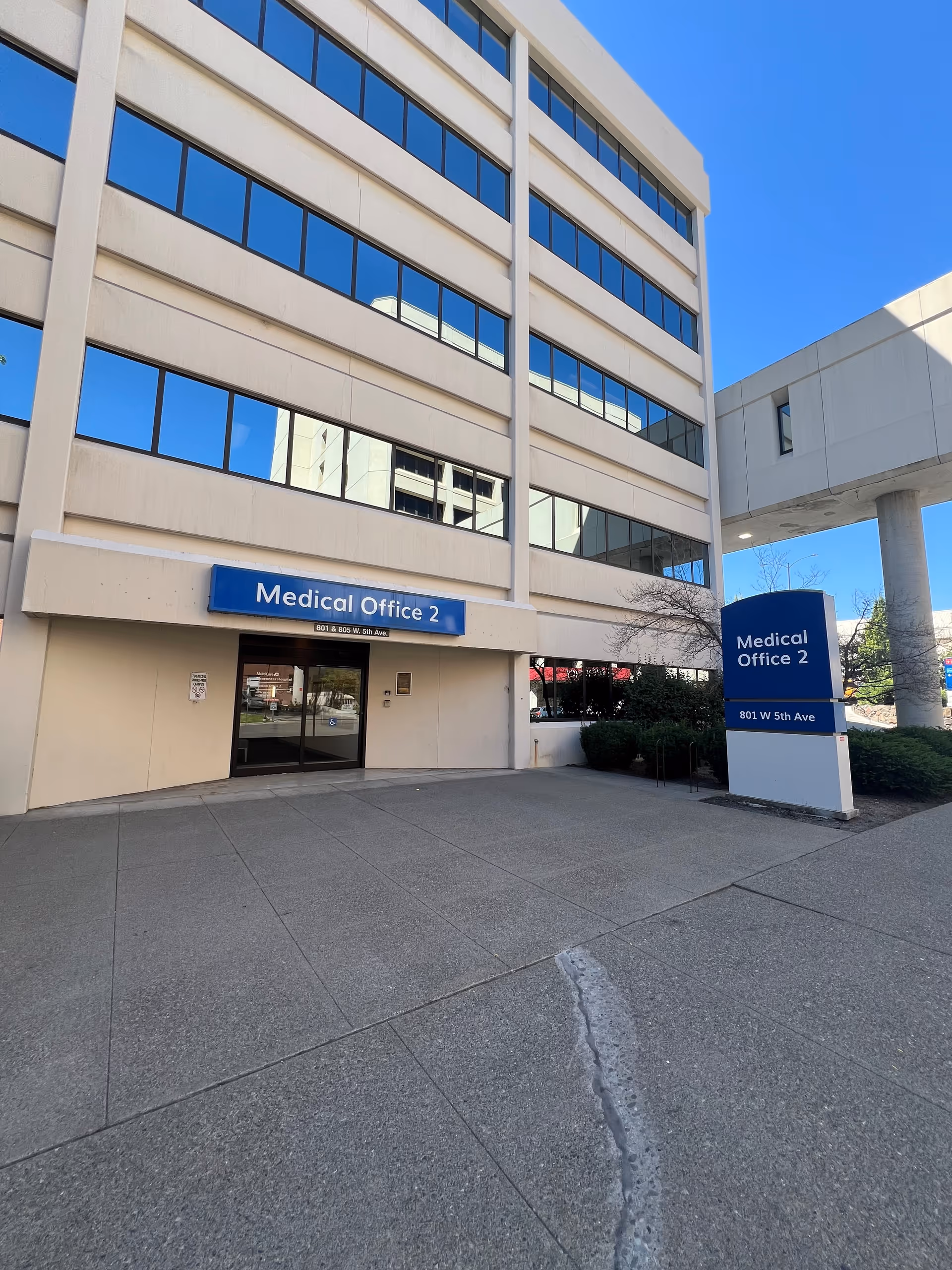 Multi-story medical office building with blue signs labeled Medical Office 2 at the entrance.