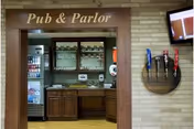 Pub and Parlor bar area with beverage coolers and beer taps.