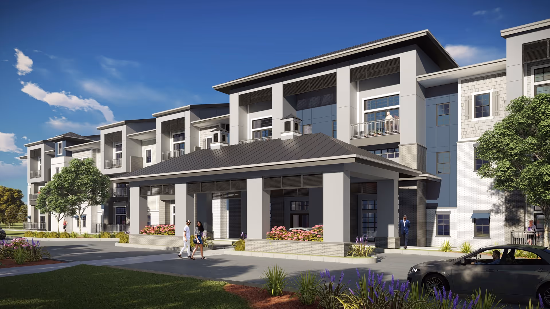 Exterior view of a modern multi-story senior living facility with a covered entrance, landscaped grounds, and several people walking and standing near the building under a clear blue sky.