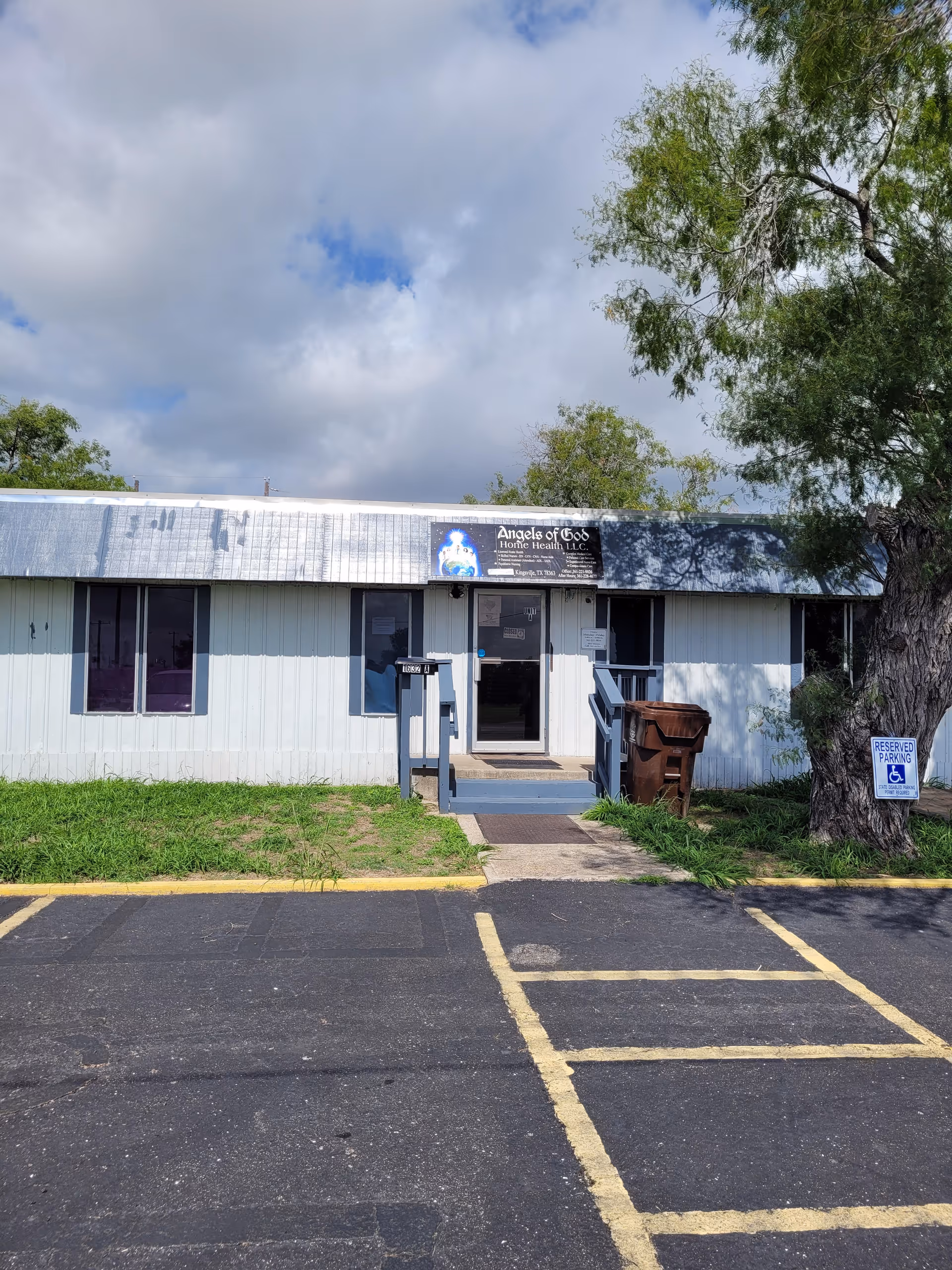 Exterior view of Angels of God Home Health LLC building with parking lot and ramp.
