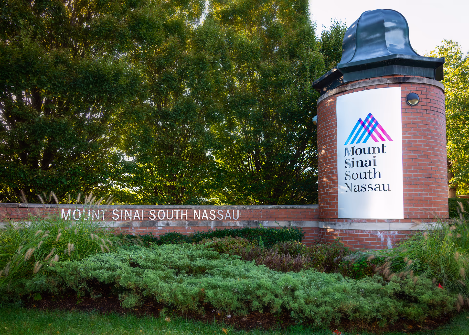 Brick entrance sign reading Mount Sinai South Nassau with surrounding greenery.
