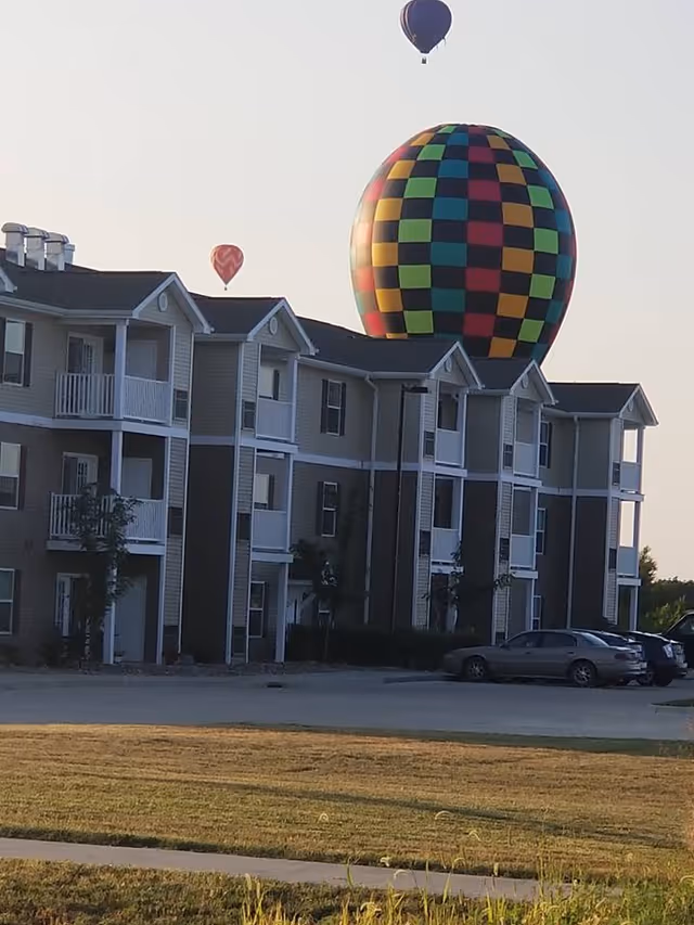 Exterior view of Connect55+ Indianola building with a colorful hot air balloon overhead