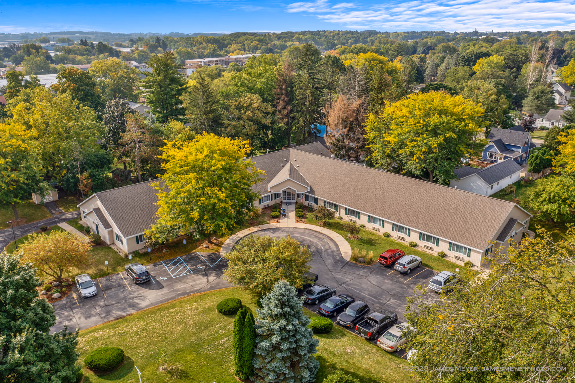 Aerial view of LakeHouse Lake Mills senior living facility surrounded by trees