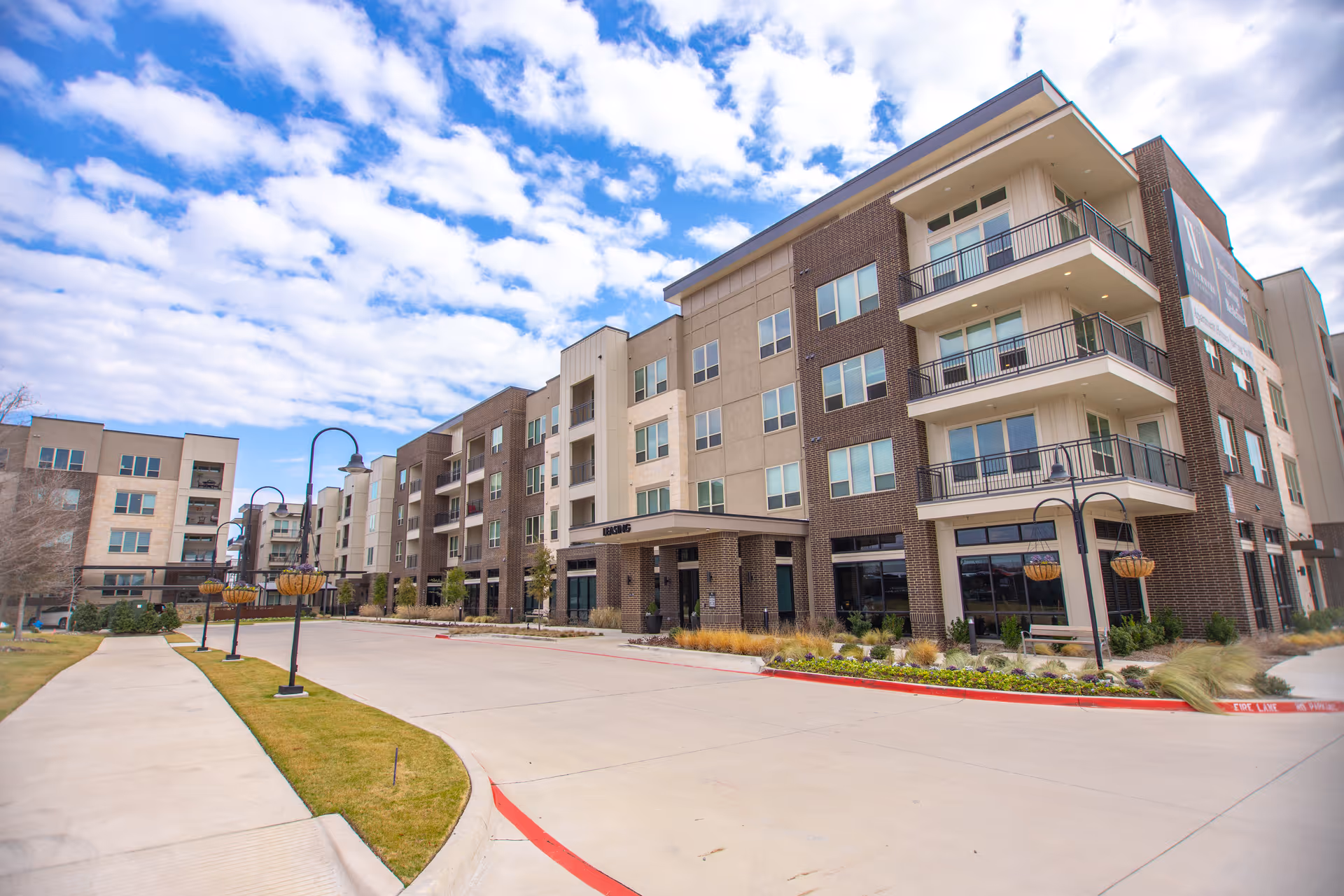 Exterior view of Watermere at Firewheel senior living campus with a multi-story building and landscaped grounds.