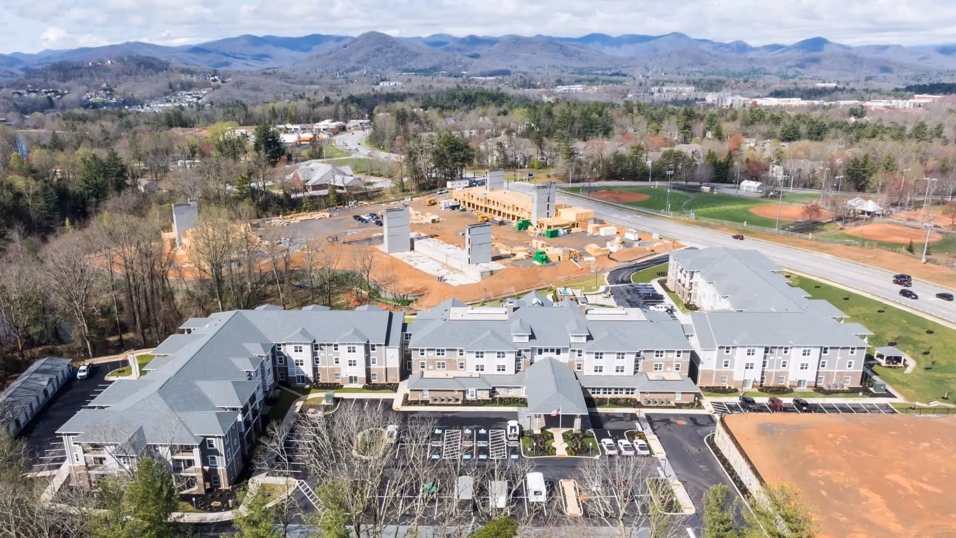 Aerial view of Pinnacle Springs Retirement Community exterior with surrounding development.