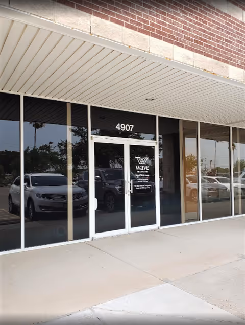 Glass storefront entrance of Wave Healthcare Rio Grande Valley, showing 4907 address.