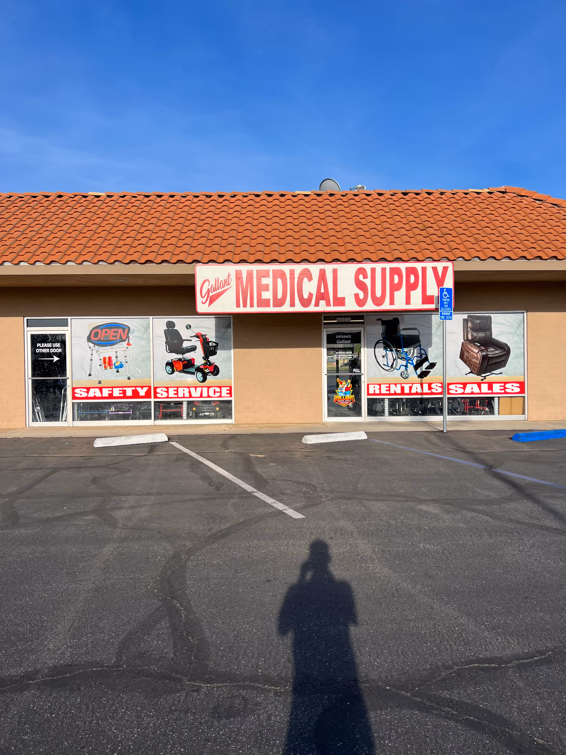 A single-story storefront labeled Gallant Medical Supply with large red signage and window advertisements.