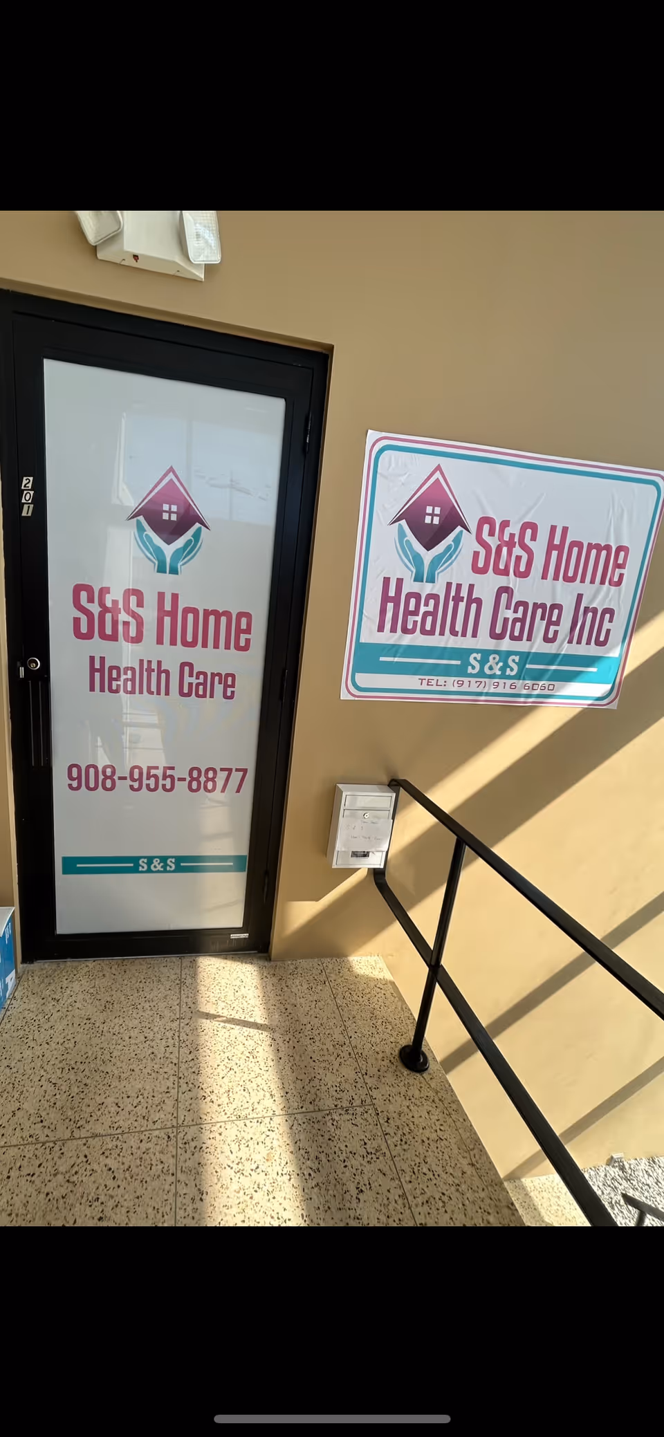 Entrance to S&S Home Health Care with signs and a railing.