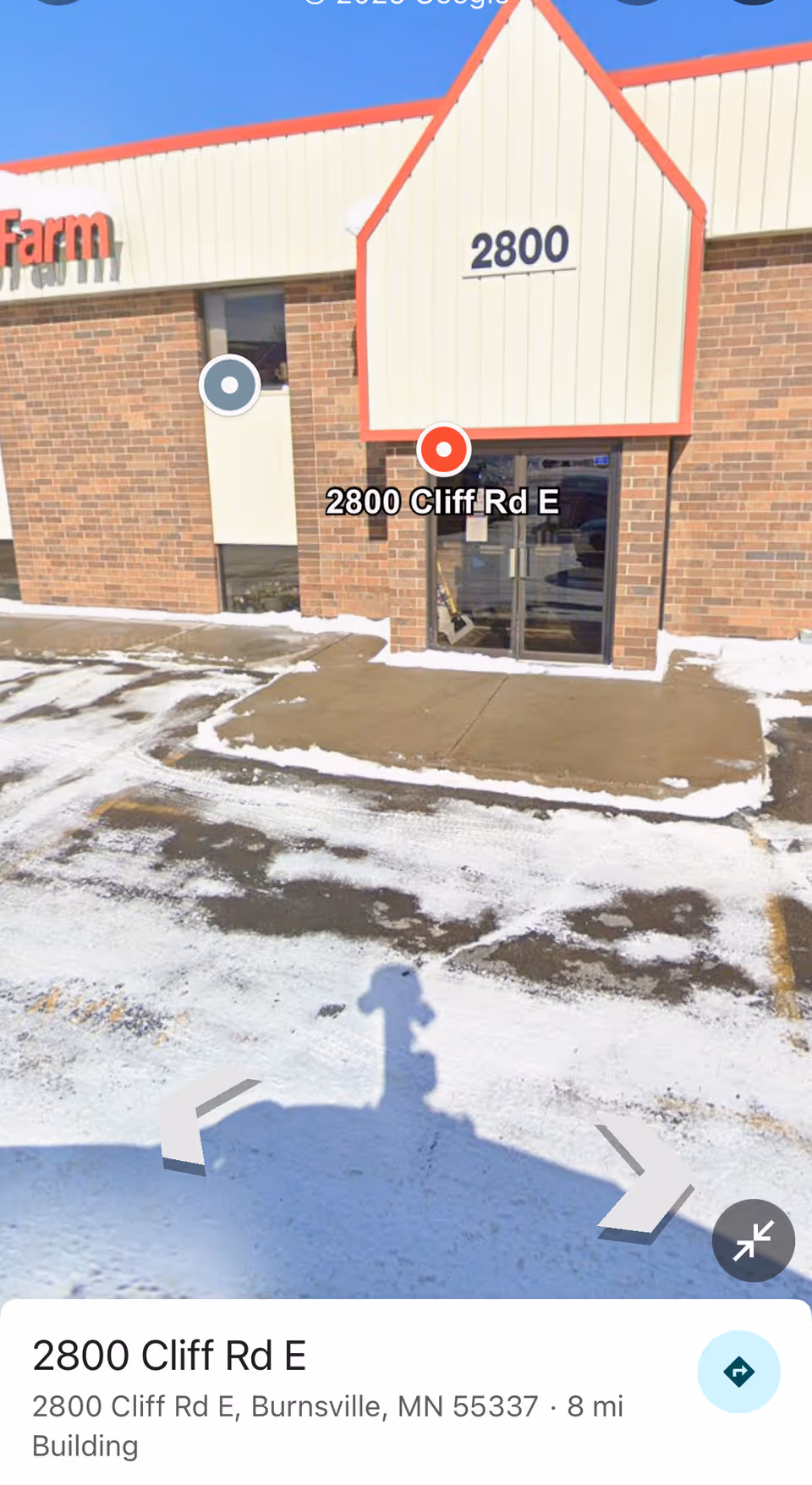 Exterior view of a brick building entrance with address 2800 Cliff Rd E and snow.