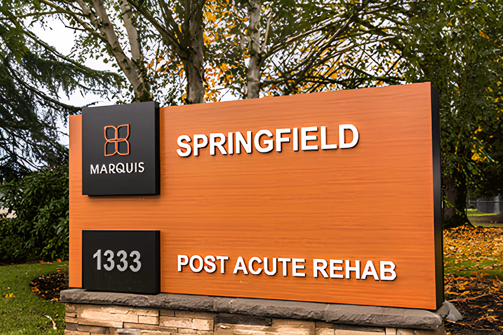 Outdoor sign for Marquis Springfield Post Acute Rehab facility with address number 1333, surrounded by trees and greenery.