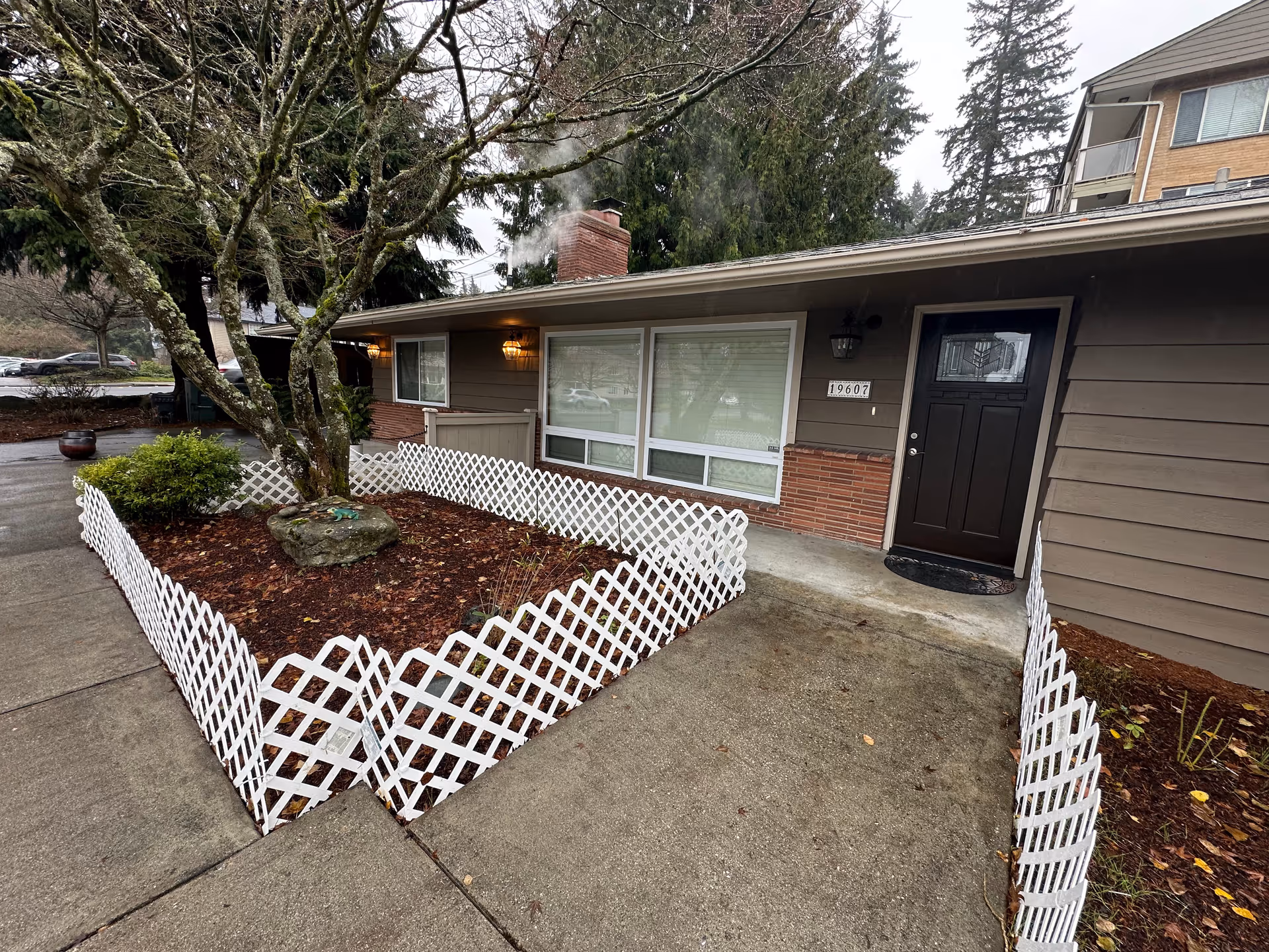 Front exterior of Peaceful Abode Adult Family Home with a small fenced garden.