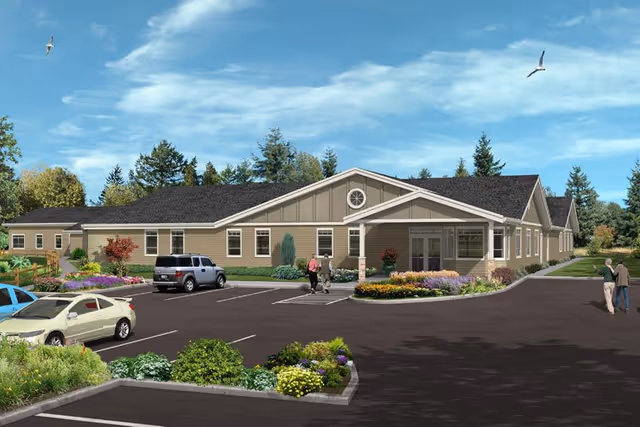 Front view of a single-story memory care facility with parking and landscaped entrance.
