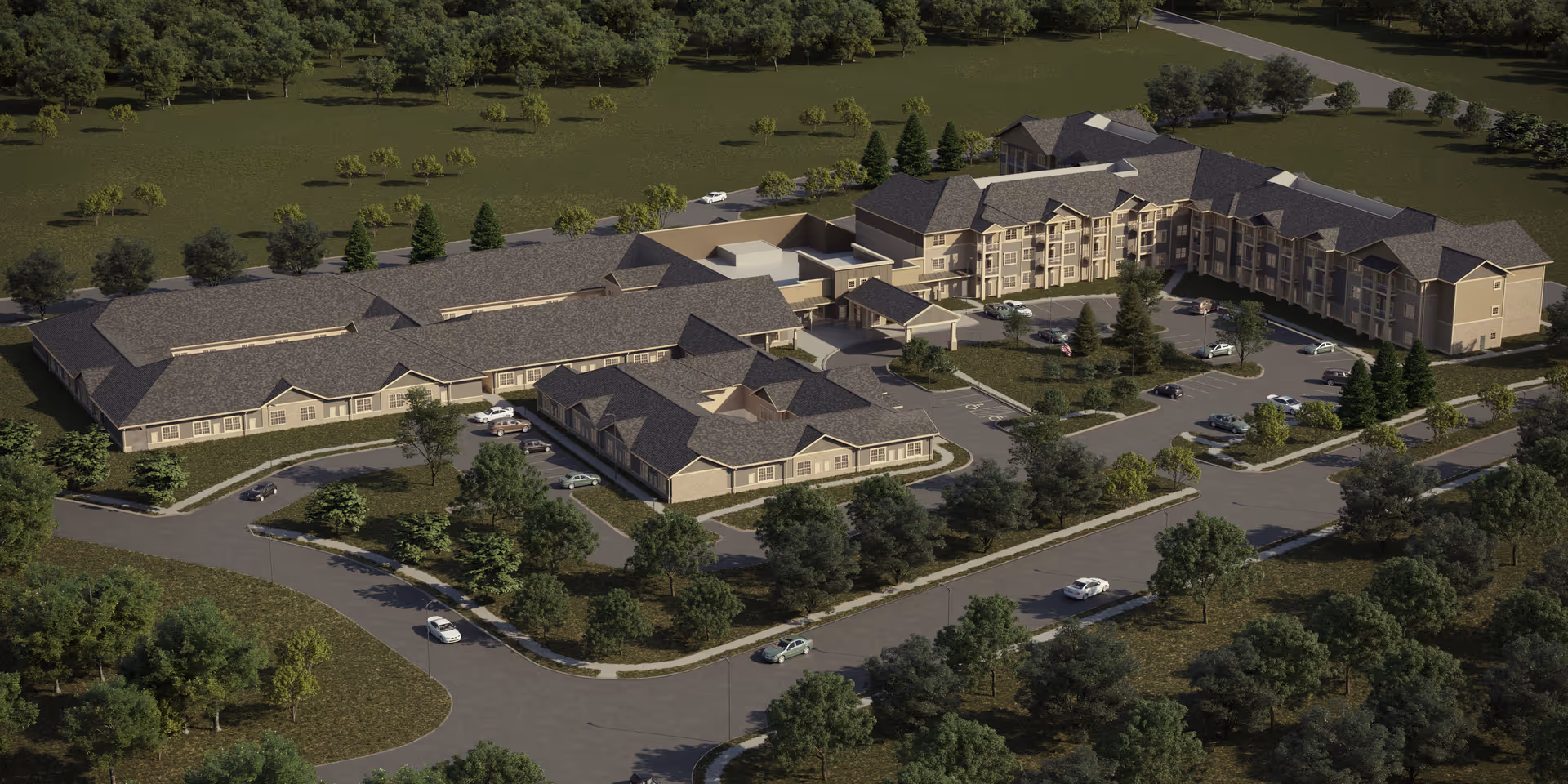 Aerial view of The Westbury Senior Living campus with tan buildings, roads, and parking.