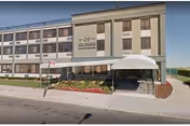 Exterior view of Beacon Rehabilitation Nursing Center with entrance, awning, and landscaping.