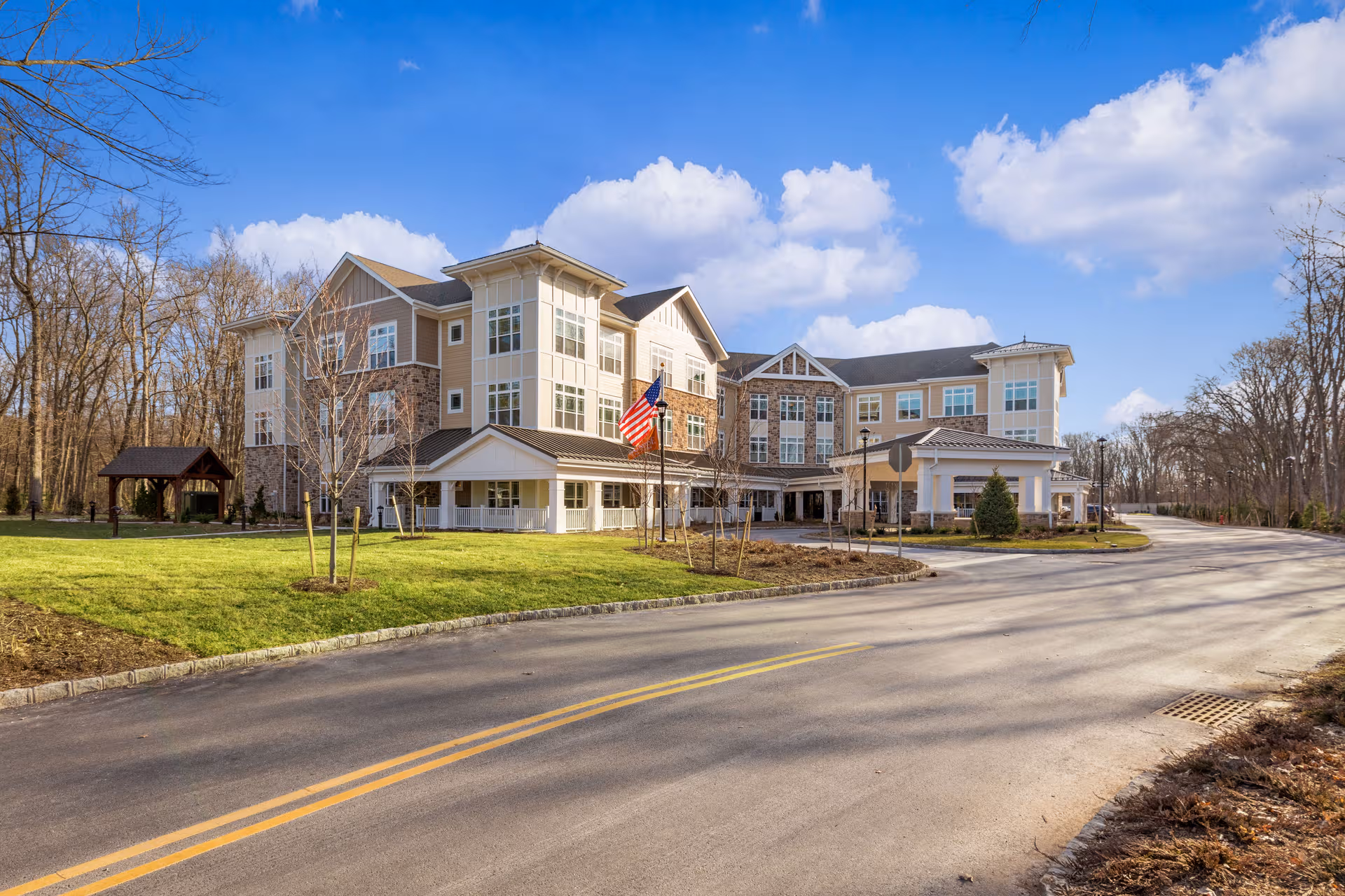 Sunrise of Livingston senior living facility exterior with entrance and flag.