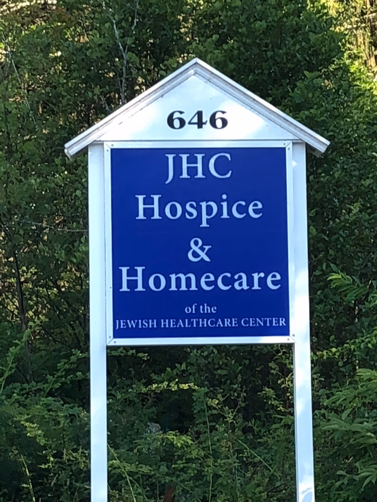 Outdoor blue sign displays JHC Hospice & Homecare of the Jewish Healthcare Center with 646