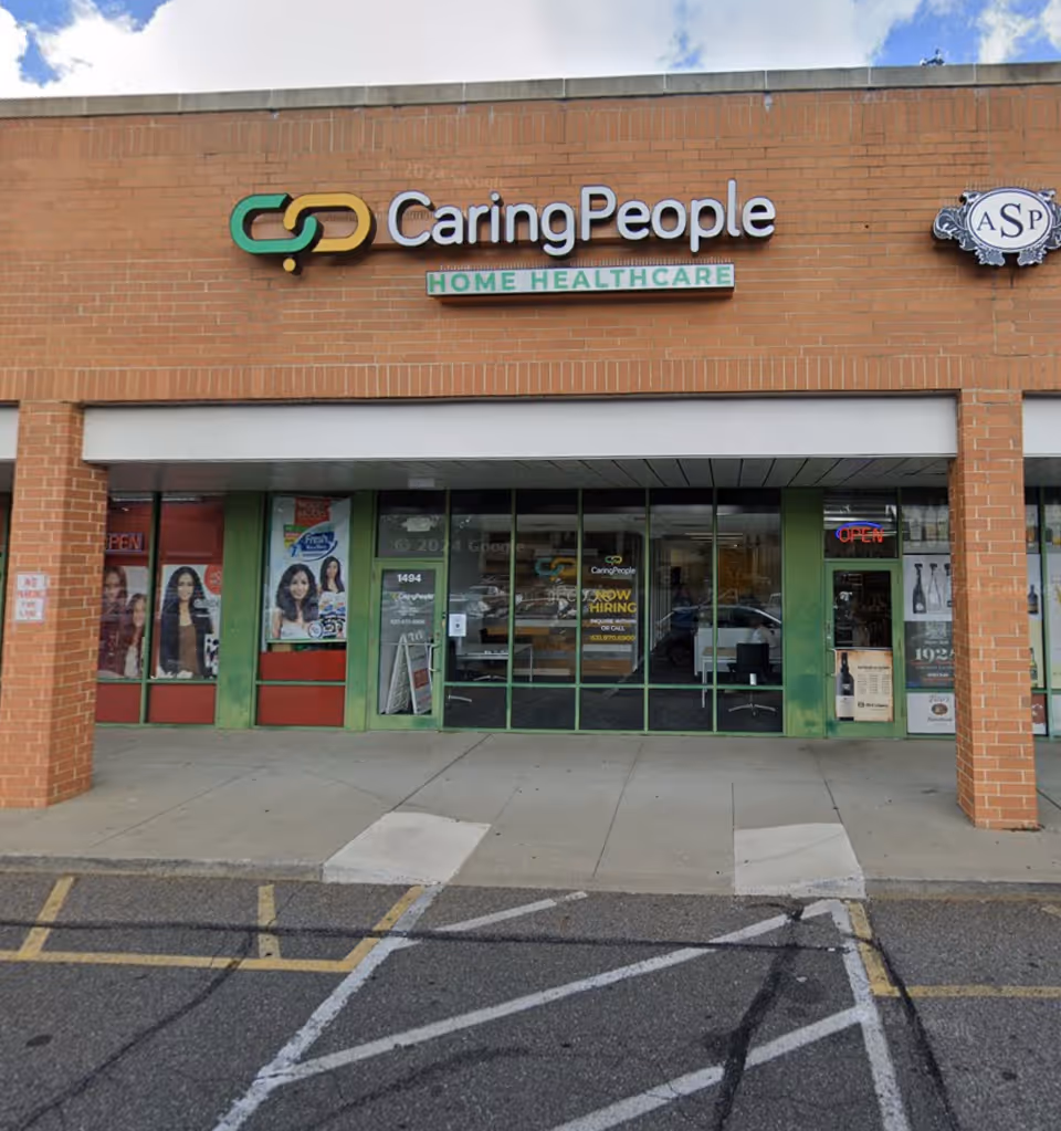Brick storefront displaying CaringPeople Home Healthcare signage and large glass entrance doors.