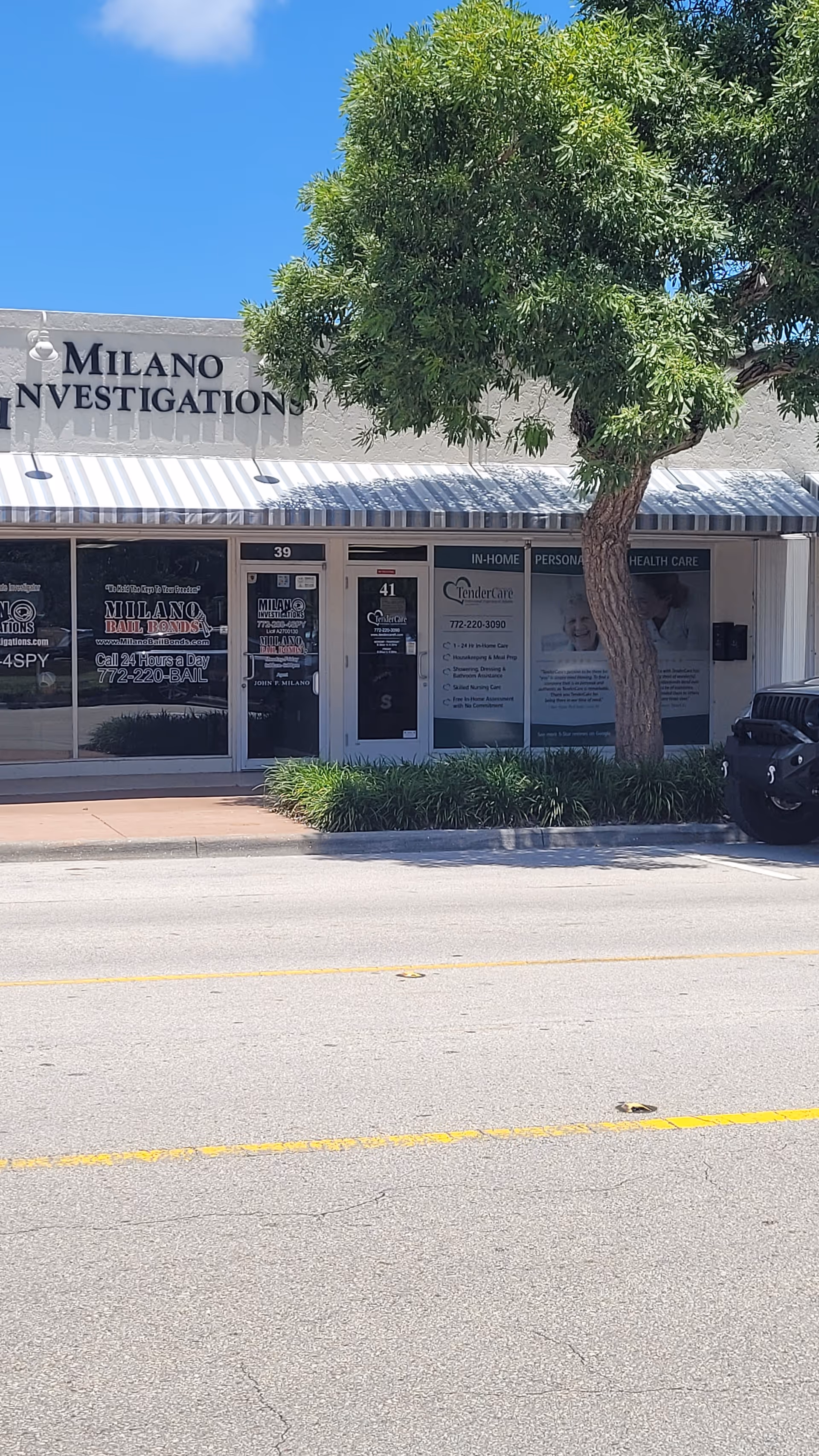 Street view of a storefront with Milano Investigation signage and a tree in front.