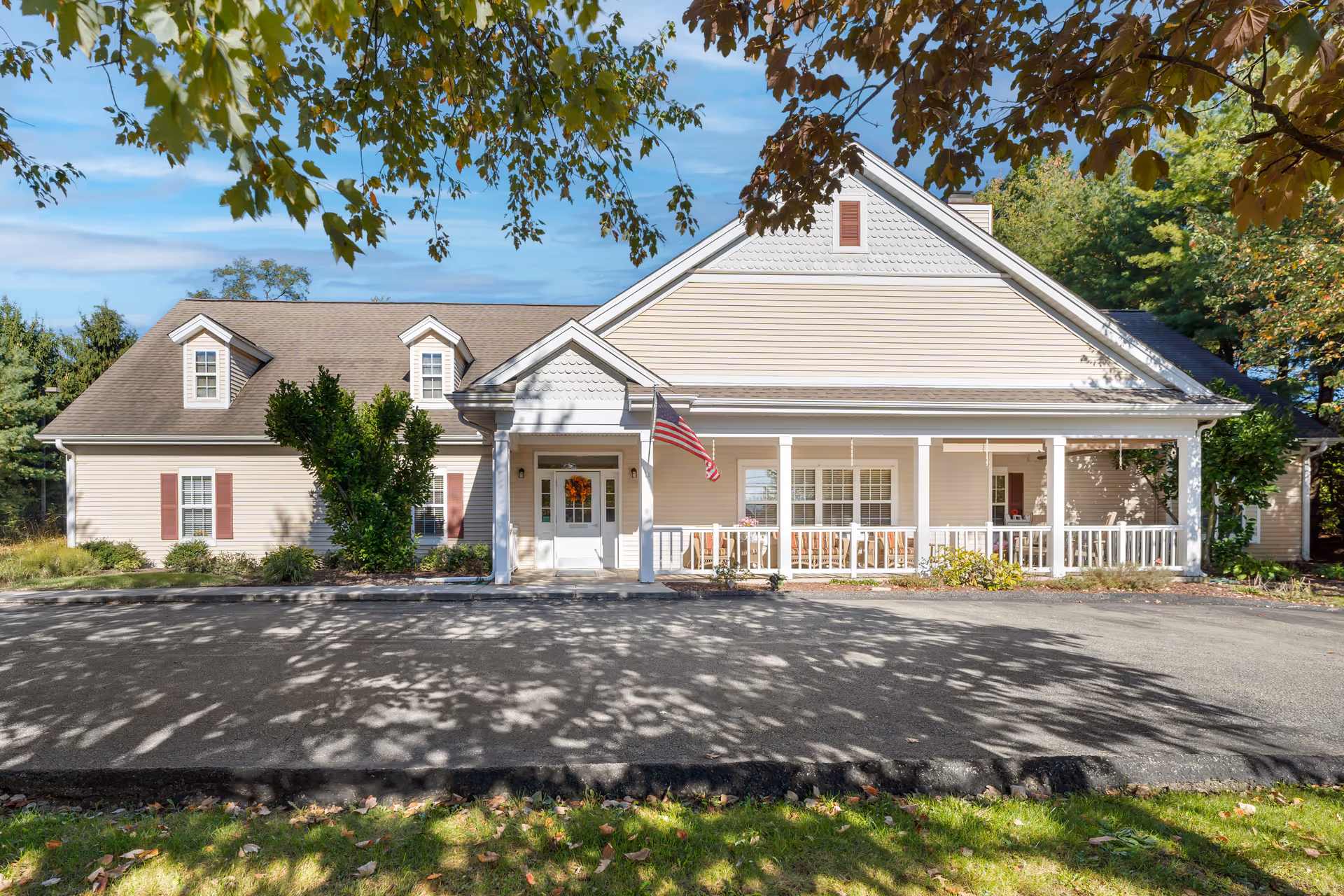 Exterior view of Brookdale Penn Hills building with a covered porch and American flag.
