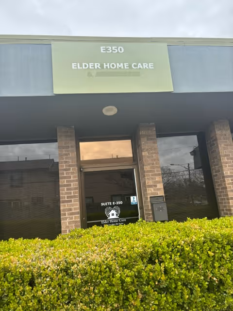 Exterior view of Elder Home Care entrance with brick pillars and glass doors.