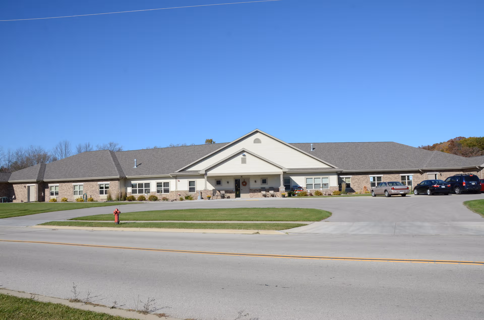 Long, single-story senior living facility with curved driveway and front entrance.