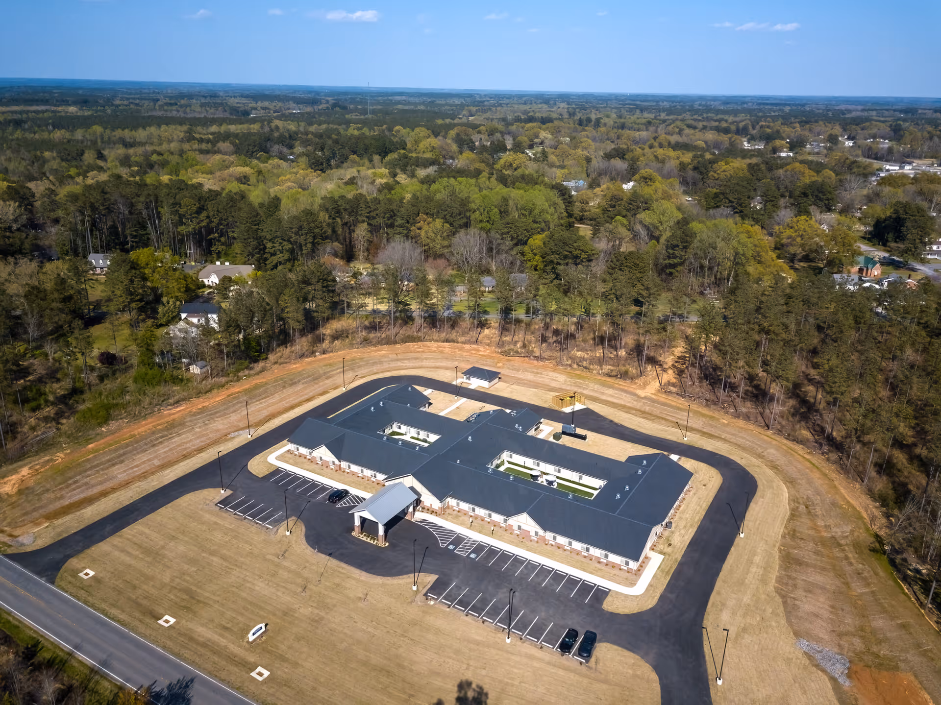 Aerial view of The Landings of Lake Gaston senior living facility with parking lot.